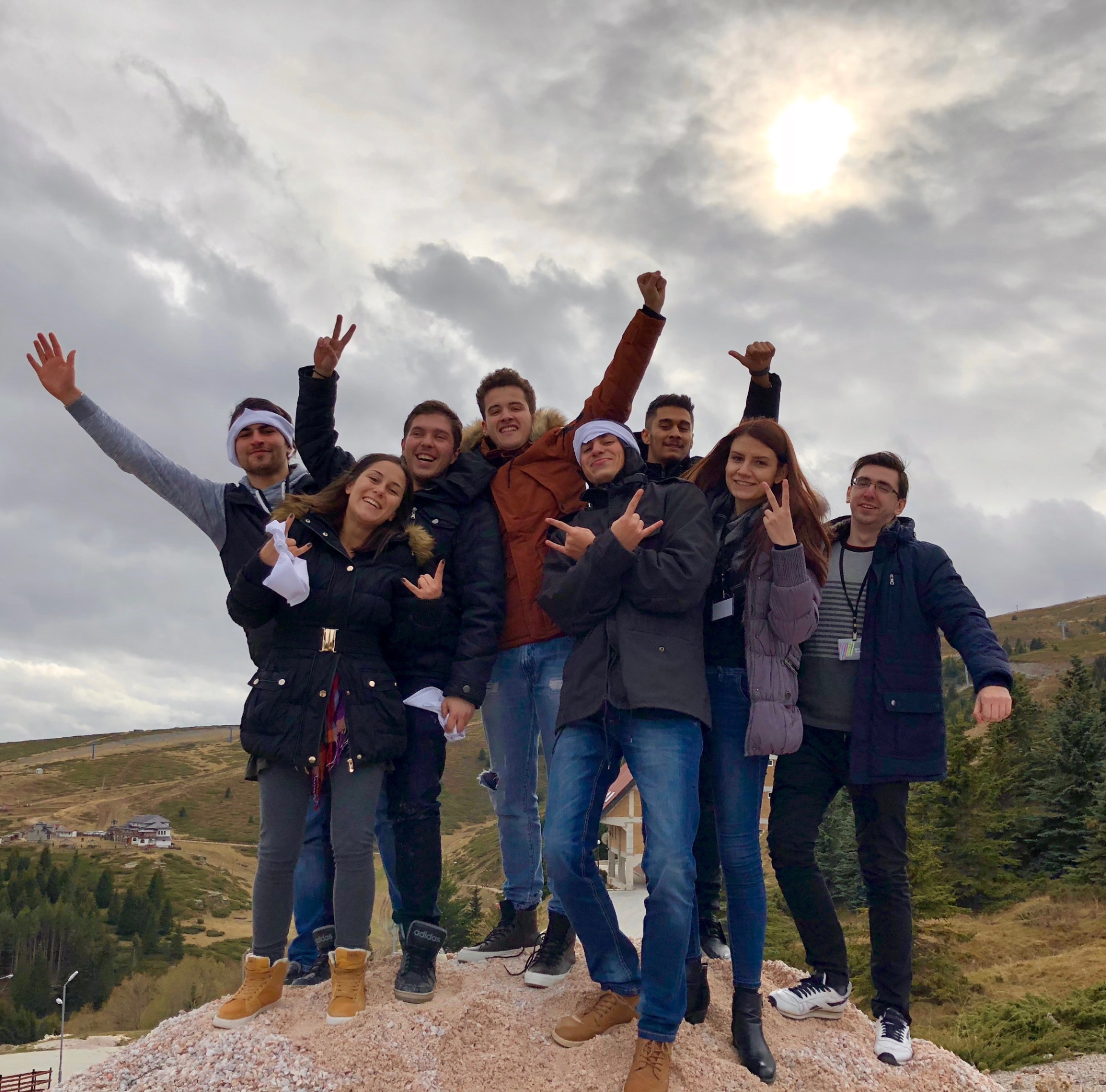 Young leaders celebrating together outdoors, demonstrating team unity and leadership development